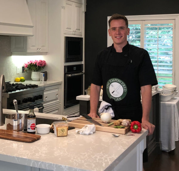 Jack Middleton posing in kitchen with vegan friendly foods